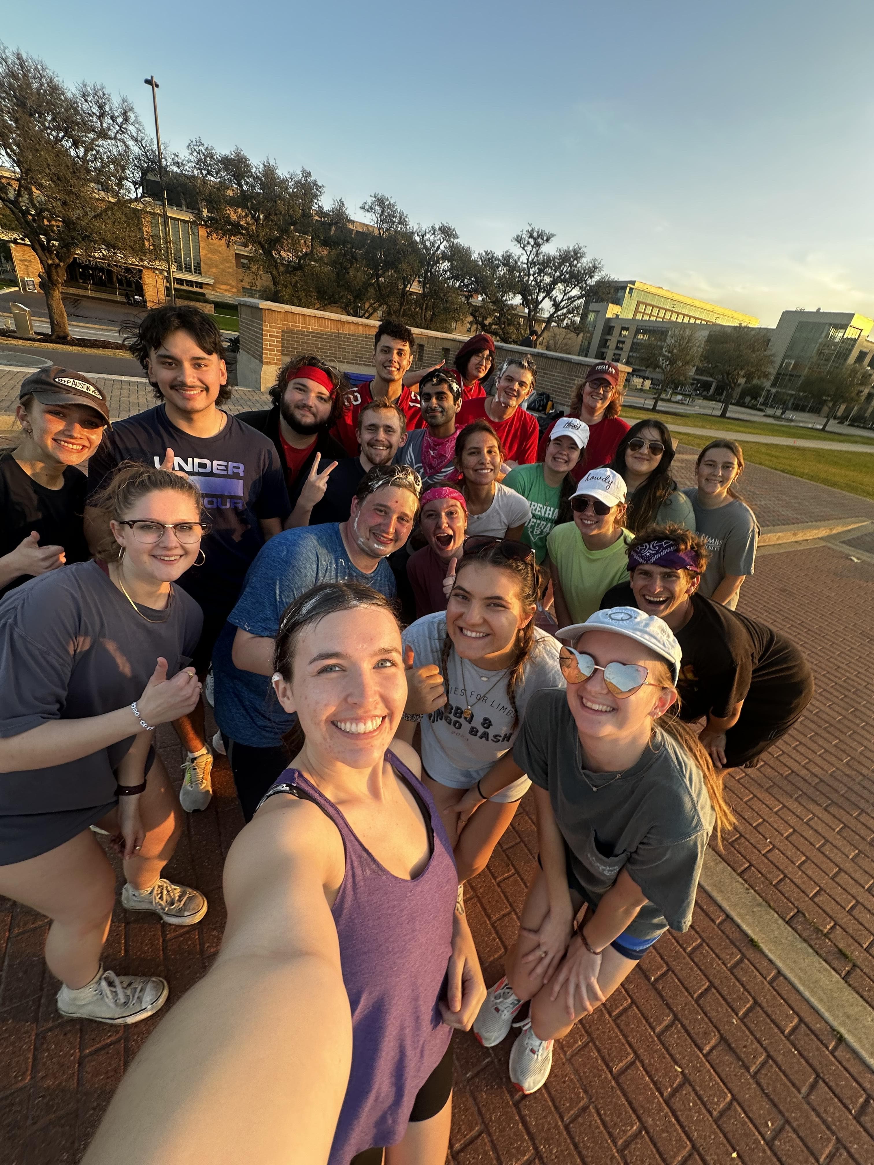 Social Committee in action - Group selfie of AFL members at sunset showing the friendly, social atmosphere of the organization