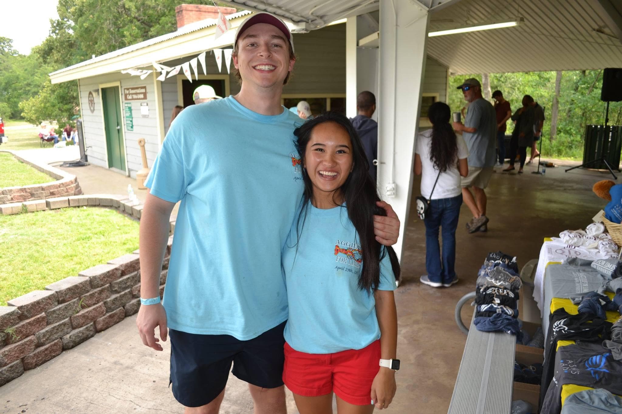 Two AFL members in event t-shirts smiling at the camera