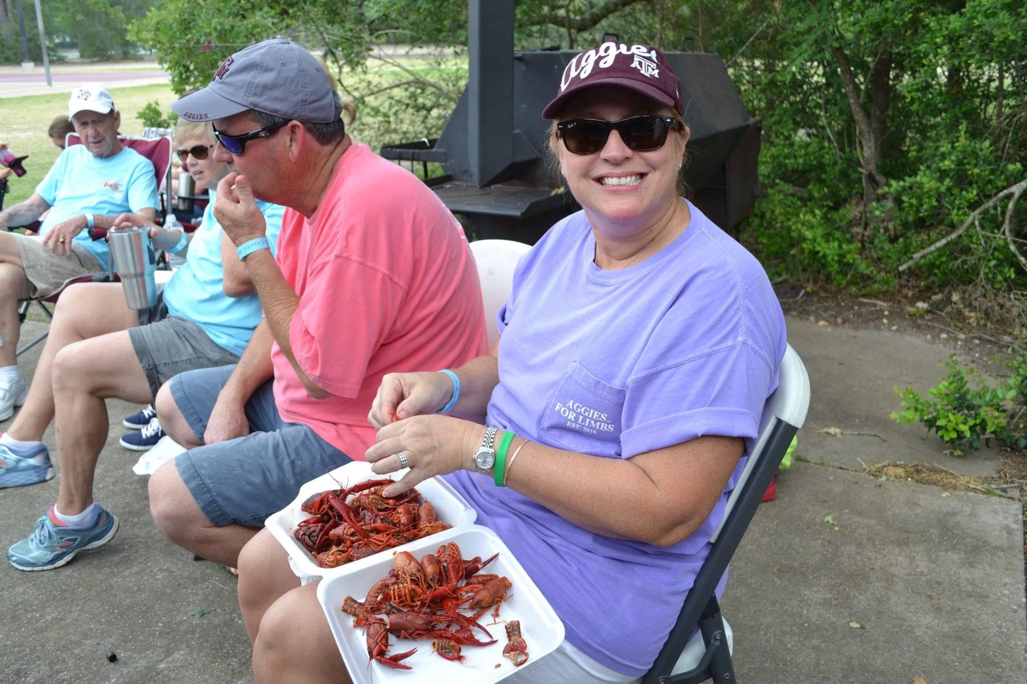 Event attendees enjoying crawfish plates outdoors